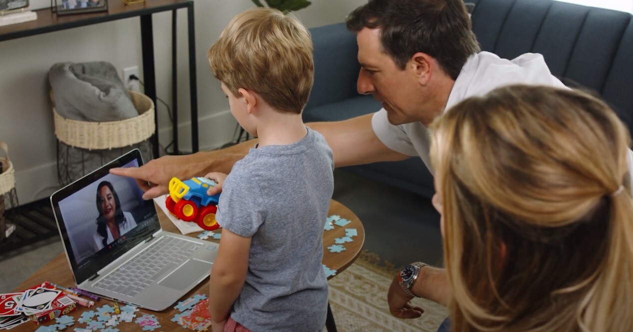 young child and family do autism evaluation virtually