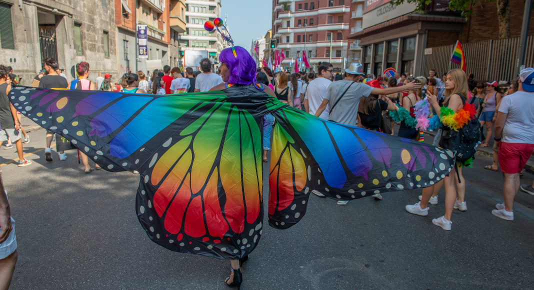 woman in rainbow butterfly costume in Pride parade