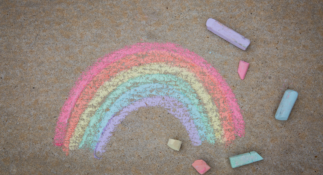 chalk drawing of a rainbow on a driveway